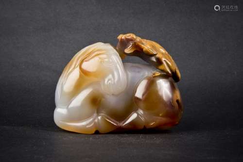 A CARVED AMBER OF HORSE