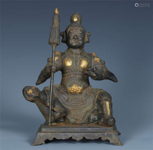 CHINESE PARTLY GILT BRONZE SEATED BUDDHIST GUARDIAN