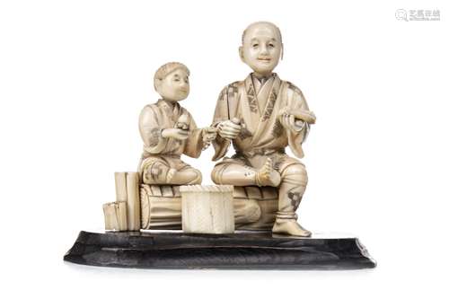 A JAPANESE CARVED IVORY FIGURE GROUP