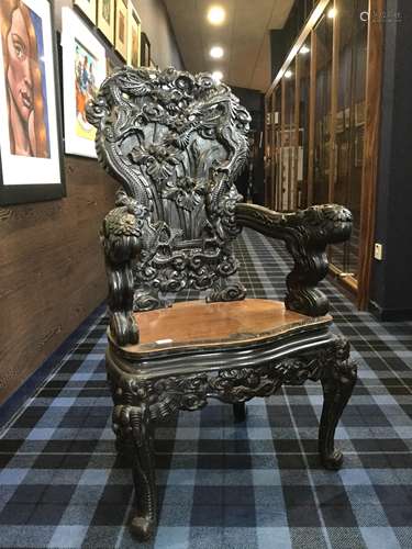 A CARVED WOOD ARMCHAIR