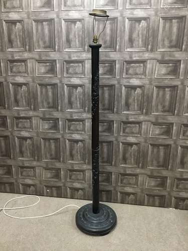 A CHINESE EBONISED CARVED WOOD STANDARD LAMP