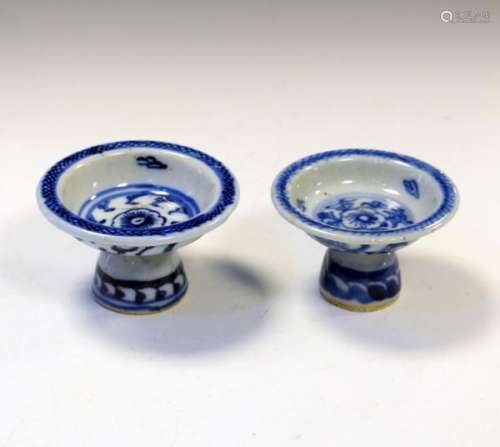 Two similar Oriental blue and white decorated shallow bowls on domed feet, 62mm high