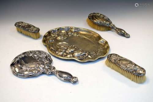 George V silver four piece dressing set with floral decoration comprising: three brushes, and a