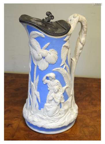 Victorian pottery relief moulded blue and white jug with decoration of a family in a tropical