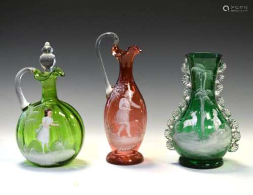Three pieces of Mary Gregory type glassware, all having enamel decoration, ewer measuring 26.5cm