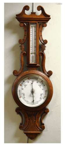 Early 20th Century carved oak aneroid barometer with mercury thermometer, 87.5cm high