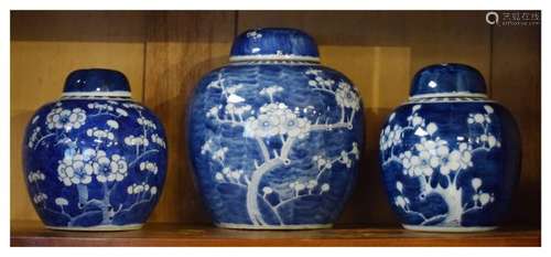 Three Oriental porcelain ginger jars and covers decorated with prunus blossom, the largest 19cm high