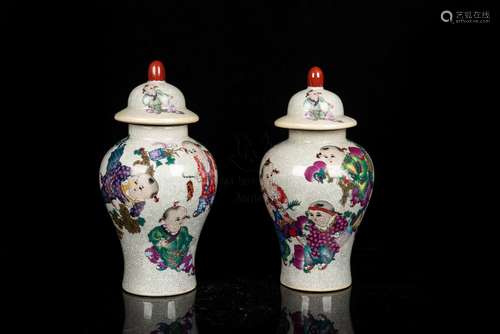 PAIR OF FAMILLE ROSE 'CHILDREN' VASES WITH COVERS