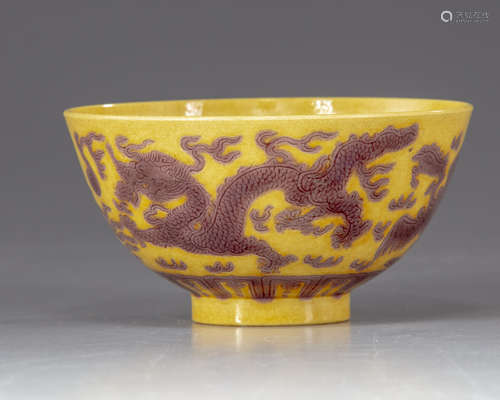 A Chinese yellow-ground aubergine-decorated 'dragon and phoenix' bowl