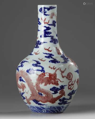 A Chinese underglaze copper-red and blue decorated 'dragon' vase