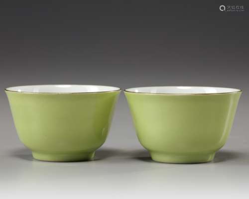 A pair of Chinese lime-green-enamelled cups