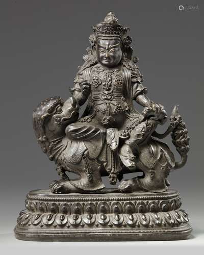 A Chinese bronze figure of Jambhala on a Buddhist lion