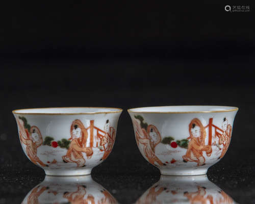 A pair of Chinese iron-red-decorated 'boys' cups