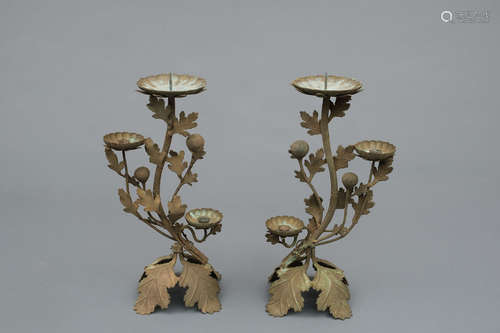 A set of two bronze candlesticks built from chrysanthemum leaves and flowers