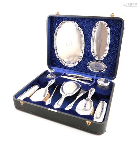 Λ A cased silver dressing table set, by Walker and…