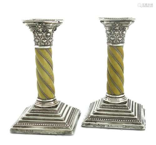 Λ A pair of Edwardian silver and ivory candlestick…