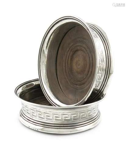 A pair of George III silver wine coasters, by John…