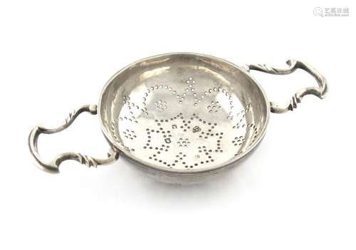 A George II silver two handled lemon strainer, by …