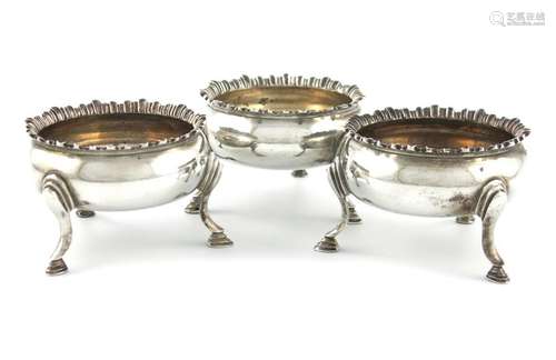 A set of three George III silver salt cellars, by …