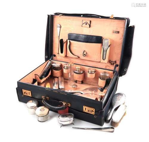 Λ A silver gilt travelling dressing table set, by …