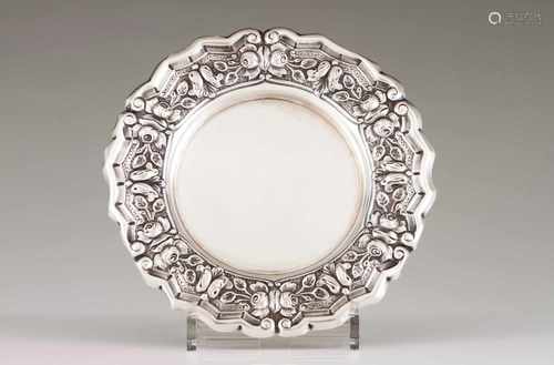 A salverPortuguese silverPlain base; scalloped lip of raised foliage scroll and volute decoration on