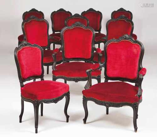 A pair of fauteuilsDarkened woodCarved decorationRed velvet covered backs, seats and