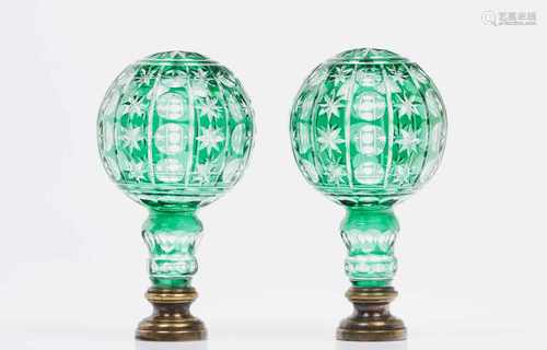 A pair of staircase finialsBlown translucent and green glassCut decorationBrass fittingsHeight: 24,5