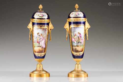 A pair of amphoraeEuropean porcelainPolychrome decoration of floral motifs and court scenesHeight: