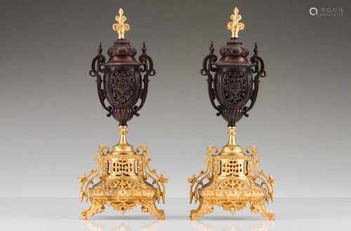 A pair of urnsGilt and patinated bronzeRaised and scalloped decoration of foliage scroll