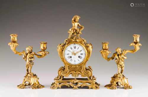 A Louis XV style garnitureTable clock and a pair of two branch candelabraGilt bronzeMoulded and