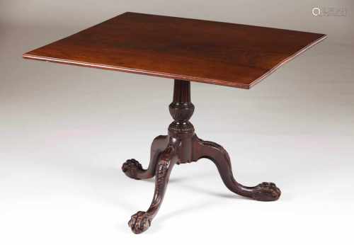 A George III tripod tableCarved central shaft and legs and lion paw feetEngland, 18th