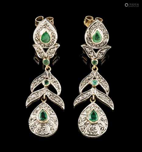 A pair of earringsGold and silverArticulated pendants set with 4 pear shaped emeralds totaling (