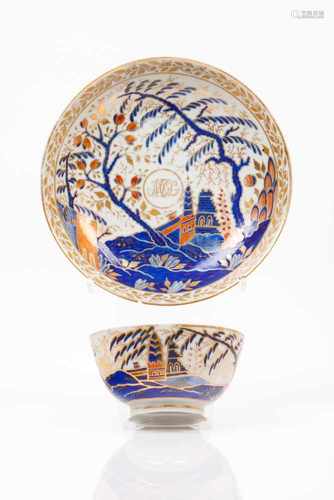 A cup and saucerChinese export porcelainRich polychrome decoration in shades of blue, salmon and