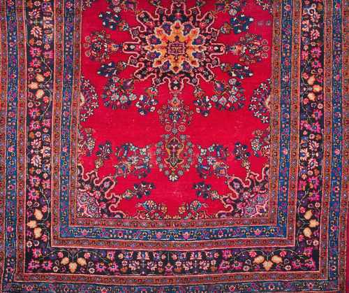 A Mashad rug, IranWool and cottonFloral pattern in bordeaux, blue and pink shades285x205 cm