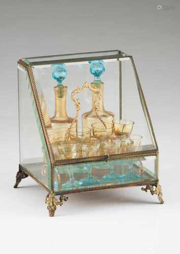 A Napoleon III liqueur cabinetGilt metal, bevelled glass and mirrorWith two blue and yellow