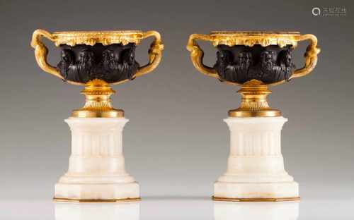 A pair of Empire bowlsPatinated and gilt bronzeMarble standsThe bowls decorated with classical masks