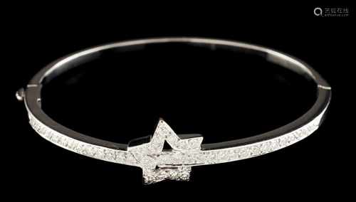 A bangleThe top with ring crossed star, both set with brilliant cut diamonds totaling (ca. 1.20ct)