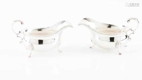 A pair of sauceboatsEnglish silverPlain with gadrooned frieze on three horse shoe feetVolute