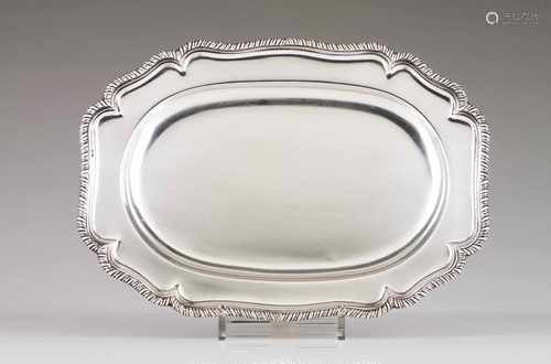 A serving trayPortuguese silverOval base with grooved and scalloped base, decorated with gadrooned