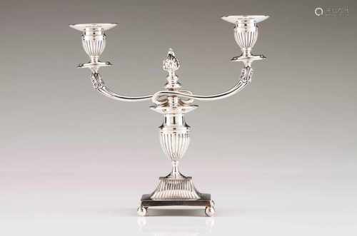 A two branch candelabraPortuguese silver, 19th / 20th centuryFluted cups, shaft and stand, on 4 ball