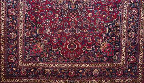 A Mashhad rug, IranWool and cotton of geometric pattern in blue, bordeaux and beige shades400x305