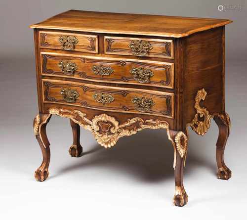 A D.João V style chest of drawersWalnut and chestnutCarved and gilt decorationScalloped apronFour