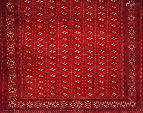 A Bukhara rug, IranWool and cotton of geometric pattern in bordeaux and beige shades300x215 cm