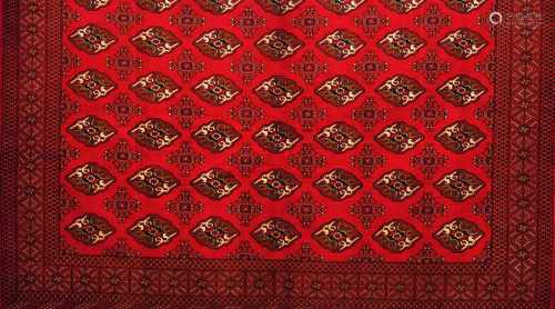 A Bukhara rug, IranWool and cotton of geometric pattern in bordeaux and beige shades375x300 cm