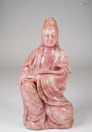 A GuanyinLarge rose quartz sculptureDepicting a seated Guanyin, holding a ruyi ceptre toped by a