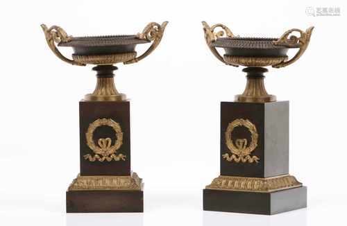 A pair of Napoleon III urnsPatinated spelter with raised and gilt decorationFrance, 19th / 20 th C.