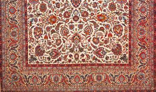 A Mashad rug, IranWool and cottonFloral pattern in beige, bordeaux, blue and pink shades(defects)