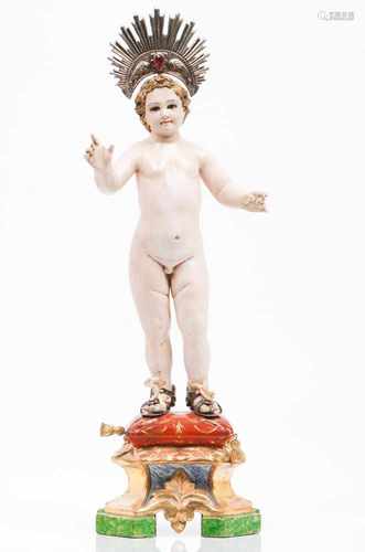 The Child JesusCarved and polychrome wooden sculpture with glass eyesSilver radiant halo and