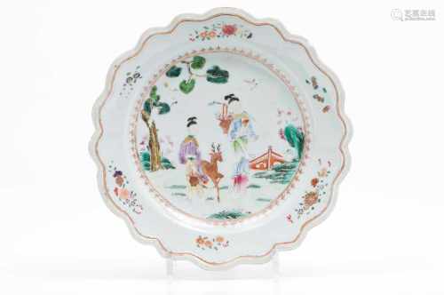 A scalloped plateChinese export porcelainPolychrome Famille Rose decoration depicting a garden