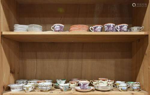 Two shelves of assorted porcelain and transferware tea